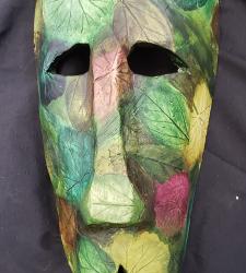 A tall and colourful clay mask