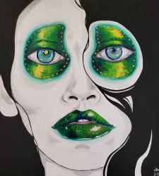 A black-and-white portrait with green eyes, eye makeup, and lips